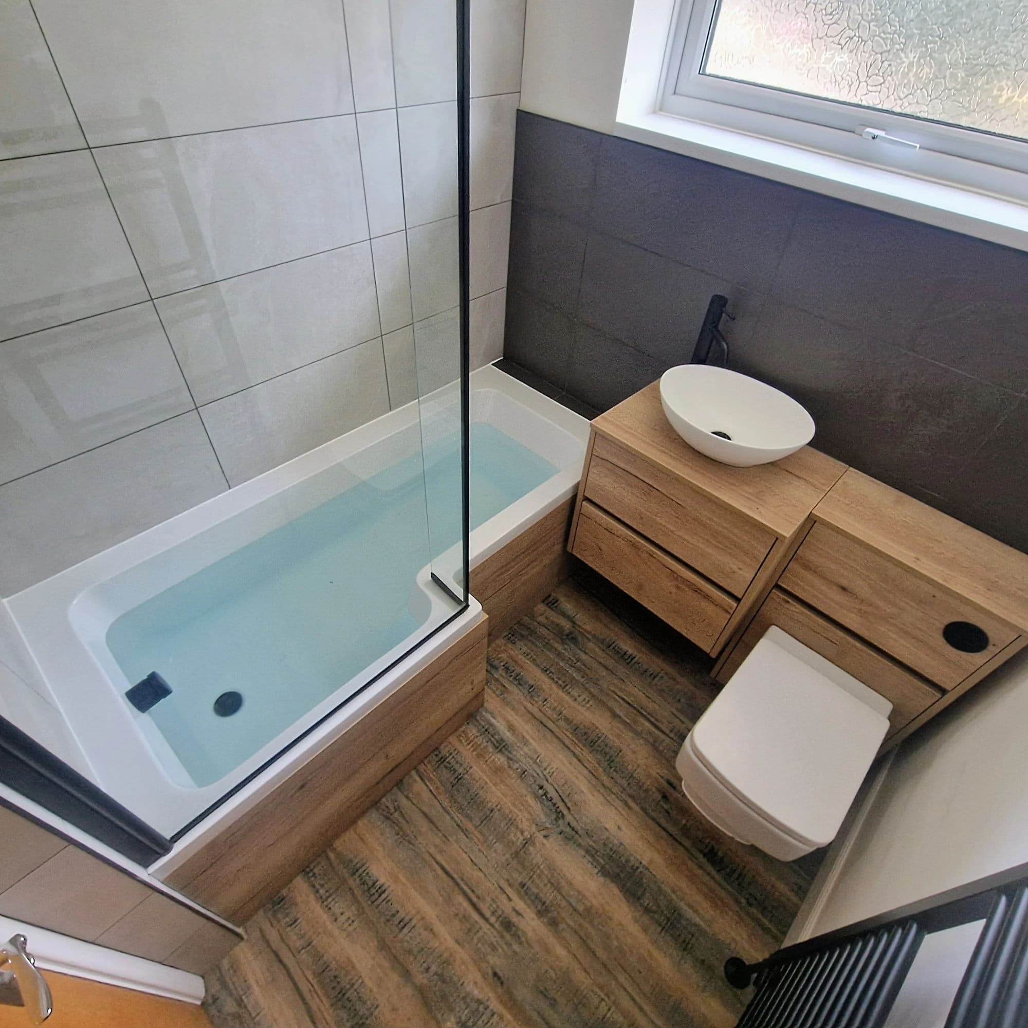 Ingleby Barwick Bespoke Bathroom Installation with Concealed Rainfall Shower in Ingleby Barwick — after completion. Services: Bathtub Installation, Plumbing, Flooring, Bathroom Tiling, Bathroom Refurbishment, Bathroom Installation, Shower Installation.