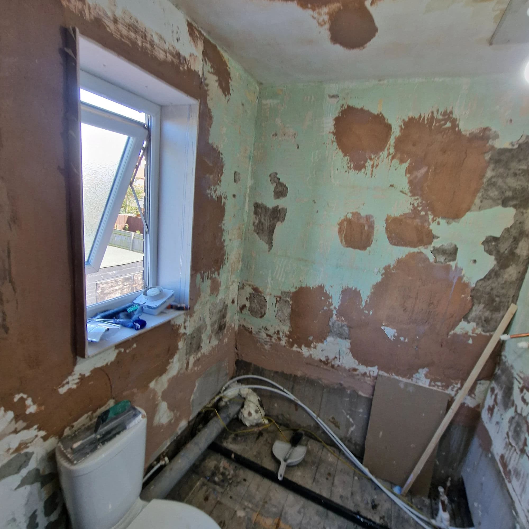 Middlesbrough Bathroom Installation and Refurbishment with P-Shaped Bath and Rainfall Shower in Middlesbrough — before work began. Services: Bathroom Installation, Bathroom Refurbishment, Bathroom Tiling, Bathtub Installation, Flooring, Plumbing, Lighting, Shower Installation, Bathroom Renovation.