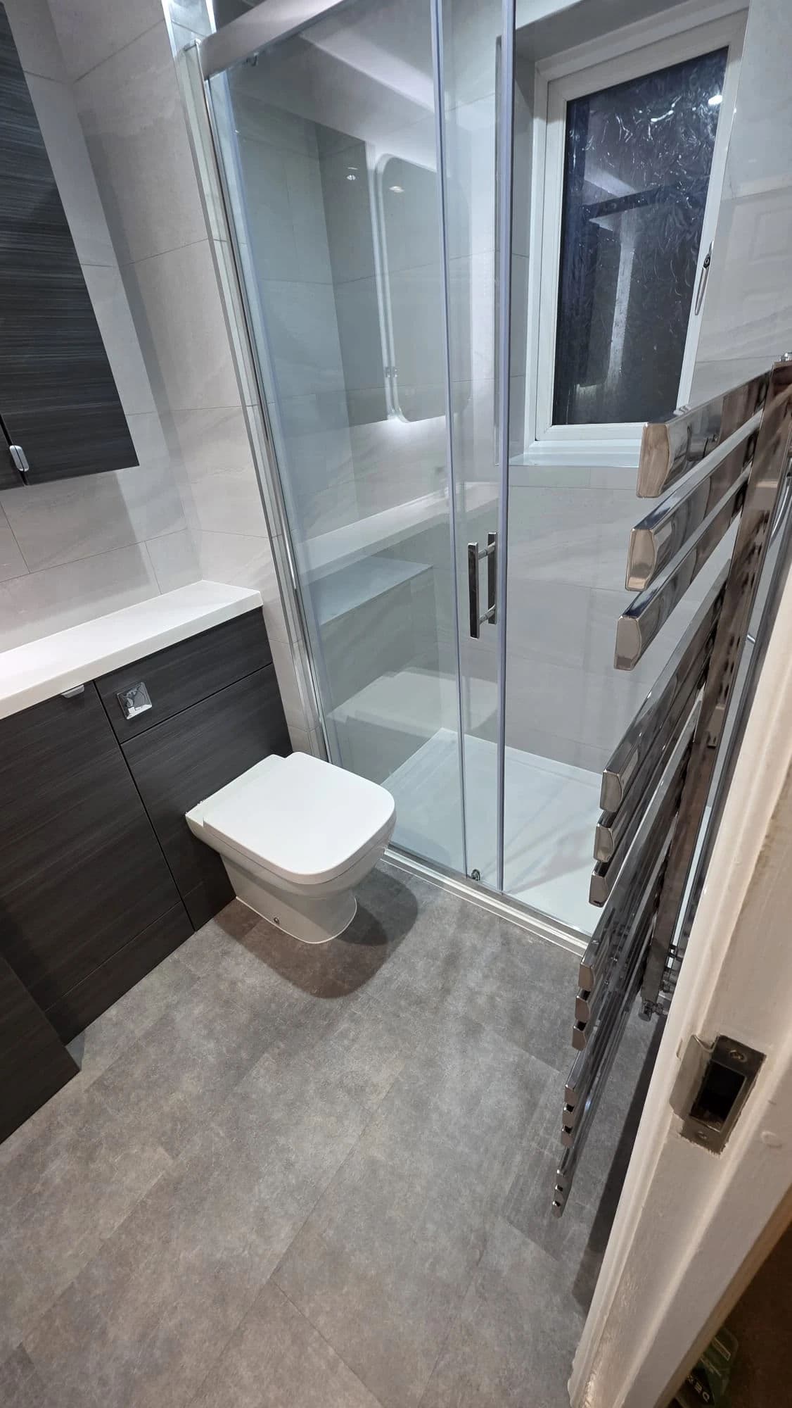 Norton Premium Bathroom Installation and Refurbishment with Large Shower and Dark Vanity in Stockton-on-Tees — after completion. Services: Bathroom Installation, Bathroom Refurbishment, Bathroom Tiling, Flooring, Shower Room, Shower Installation, Plumbing, Lighting, Bathroom Renovation.
