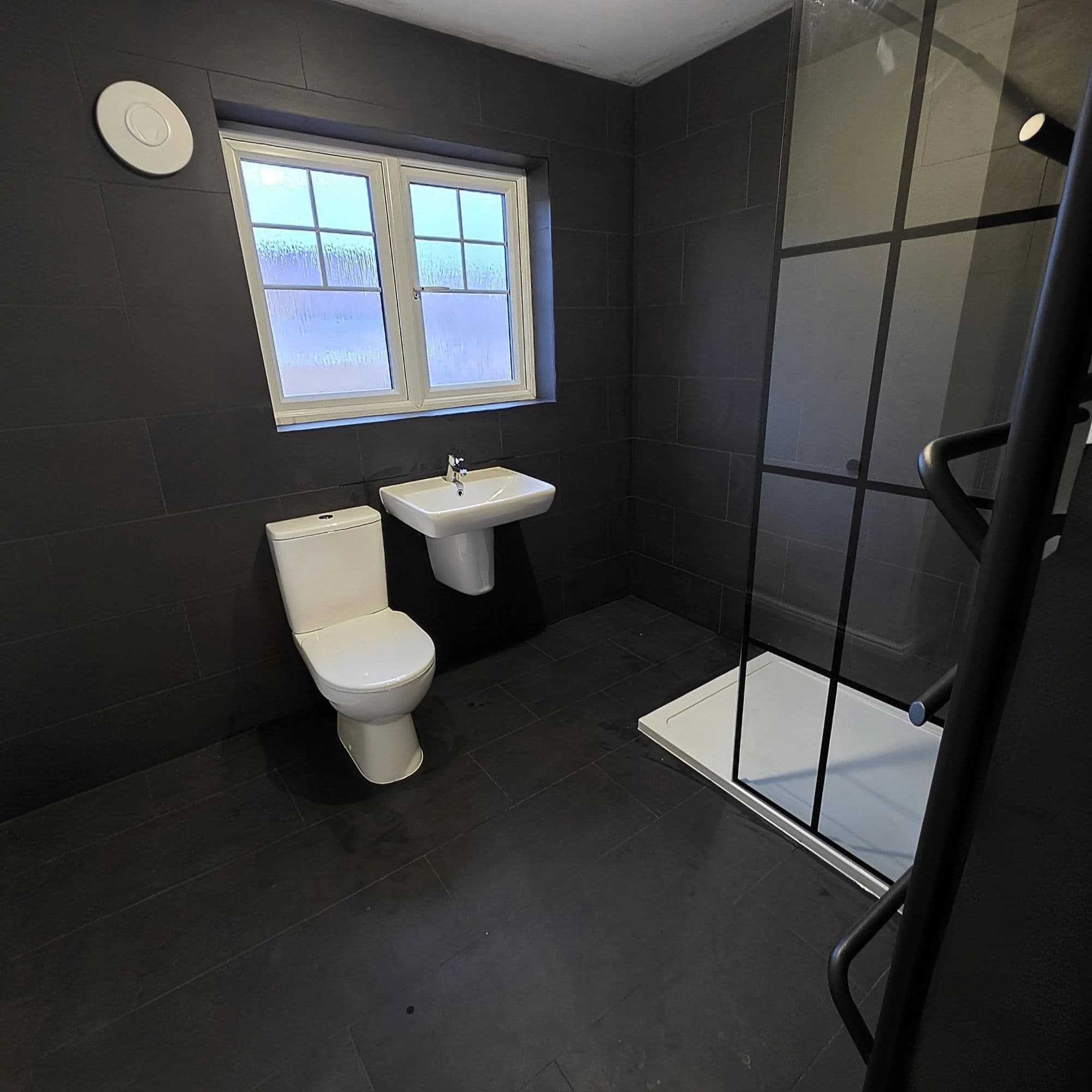 Hemlington Bathroom Refurbishment with Black-Framed Shower Screen in Middlesbrough — after completion. Services: Bathroom Installation, Bathroom Renovation, Bathroom Refurbishment, Shower Installation, Plumbing, Bathroom Tiling.