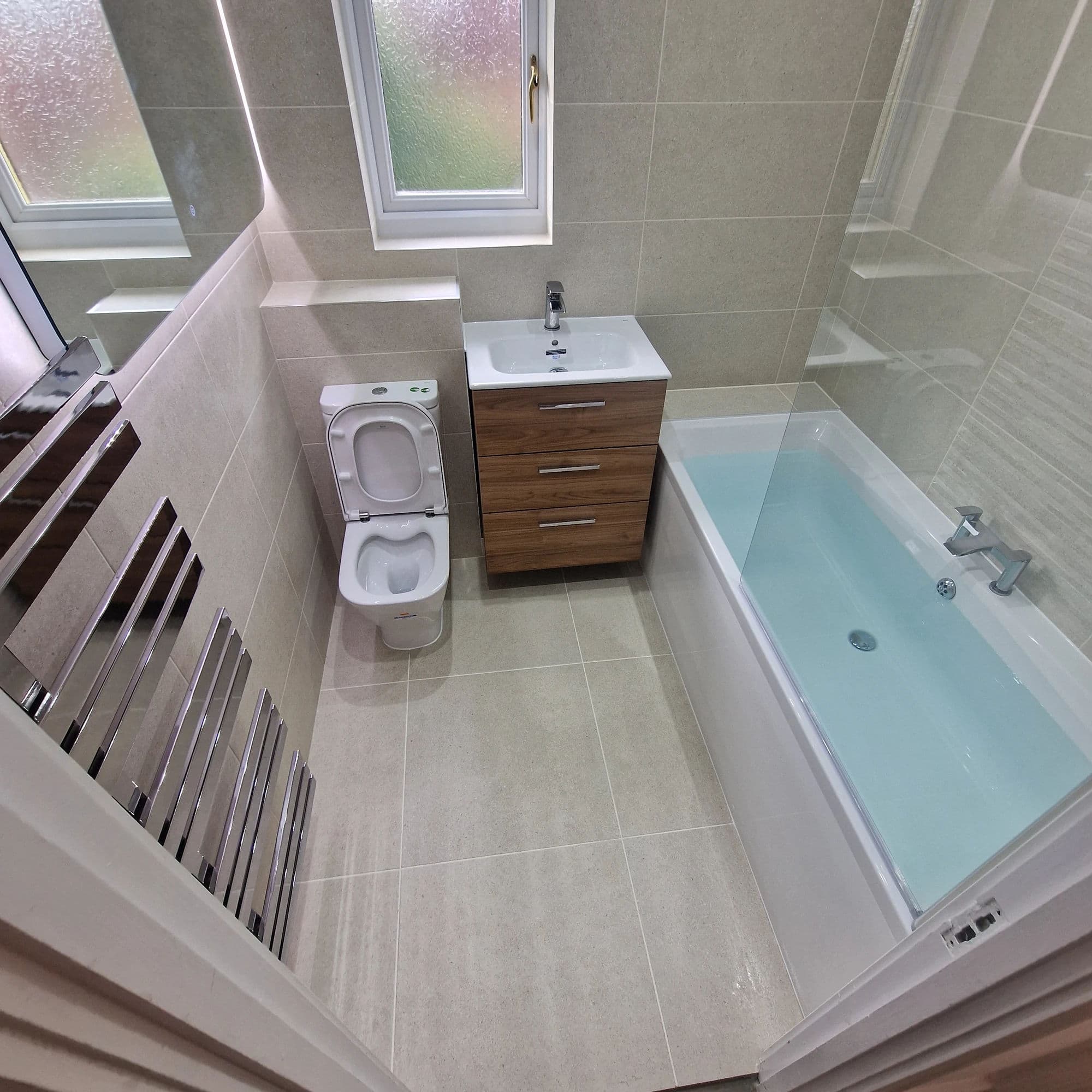 Ingleby Barwick Premium Bathroom Installation and Refurbishment with Over-Bath Shower in Ingleby Barwick — after completion. Services: Bathroom Installation, Bathroom Renovation, Bathroom Tiling, Bathtub Installation, Flooring, Plumbing, Lighting, Shower Installation.